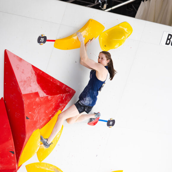 Erin McNeice matches the final hold of a boulder to become an Olympian at the Paris 2024 OQS event